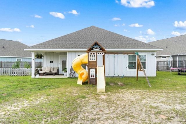 5722 Conley Ct, Pace, FL 32571 - rear view of house with a trampoline, board and batten siding, a playground, an outdoor hangout area, and roof with shingles