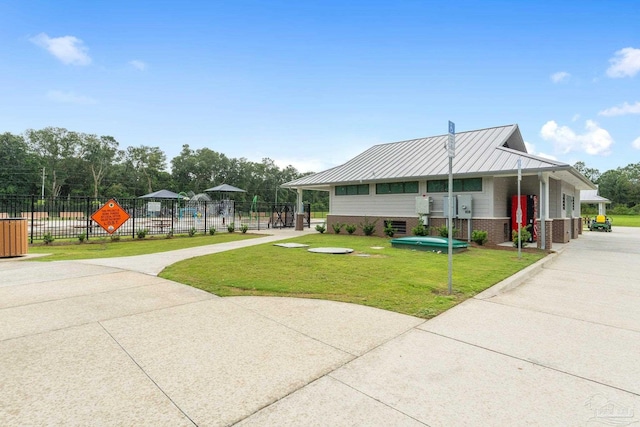 5722 Conley Ct, Pace, FL 32571 - view of front of home with metal roof, brick siding, and driveway