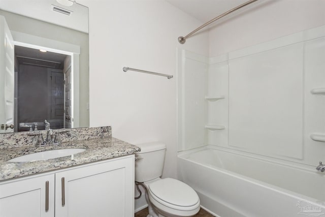 full bathroom featuring shower / bath combination, vanity, and toilet