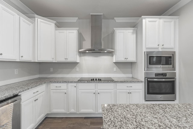 kitchen with white cabinets, appliances with stainless steel finishes, crown molding, and wall chimney exhaust hood