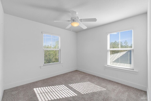 spare room with light colored carpet and ceiling fan