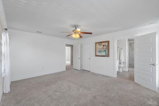 interior space with ceiling fan and ornamental molding