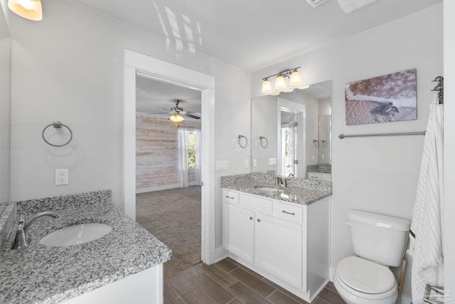 bathroom with ceiling fan, vanity, and toilet