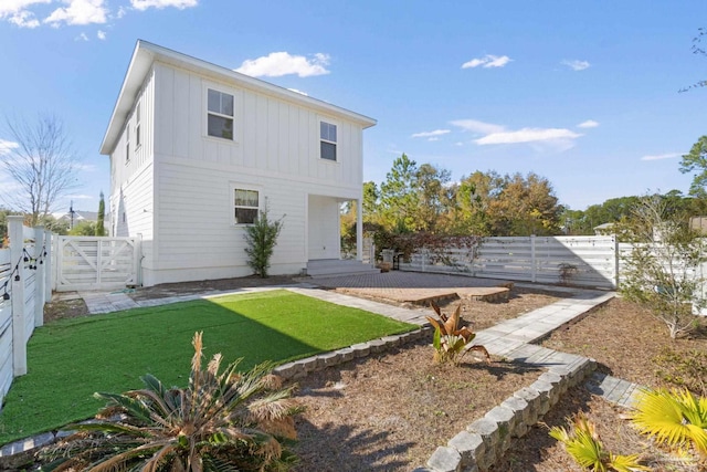 rear view of property featuring a yard