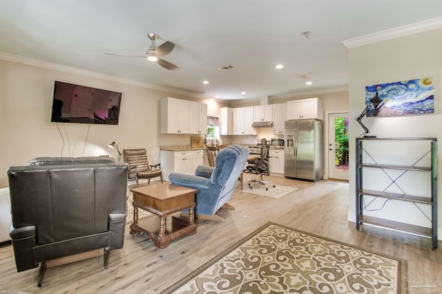 living area featuring crown molding, ceiling fan, and a wealth of natural light