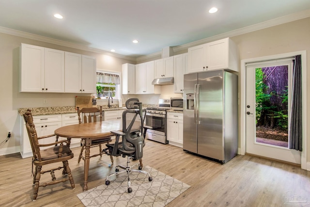 kitchen with crown molding, a sink, stainless steel appliances, white cabinetry, and under cabinet range hood