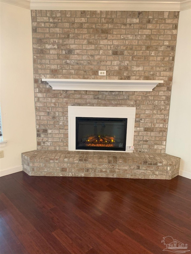 details featuring hardwood / wood-style floors and a fireplace