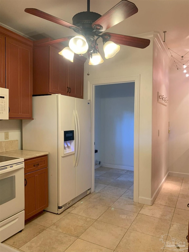 kitchen featuring ceiling fan, light tile patterned floors, and white appliances