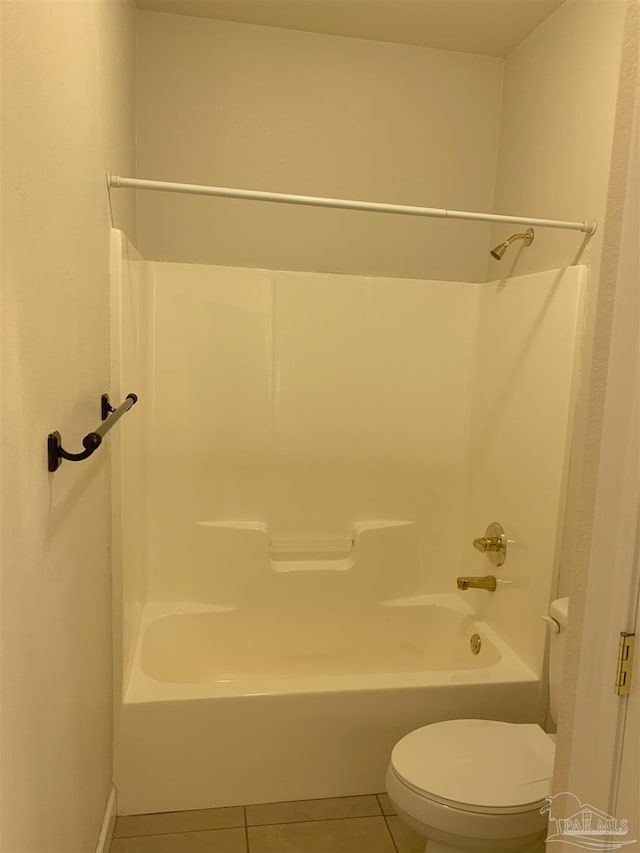 bathroom featuring tile patterned floors, bathing tub / shower combination, and toilet