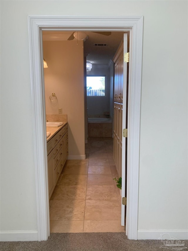 bathroom with tile patterned flooring and vanity