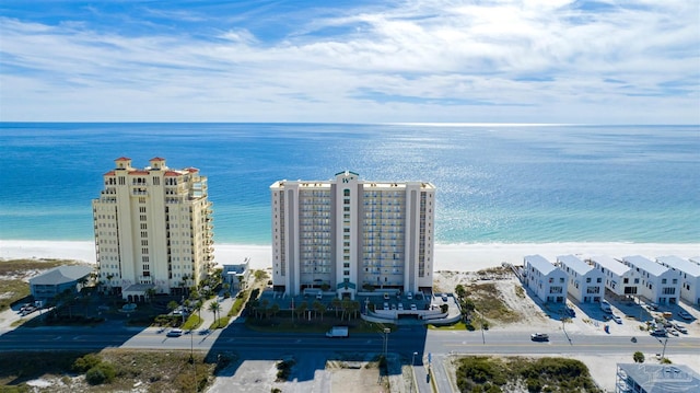 birds eye view of property with a water view and a beach view