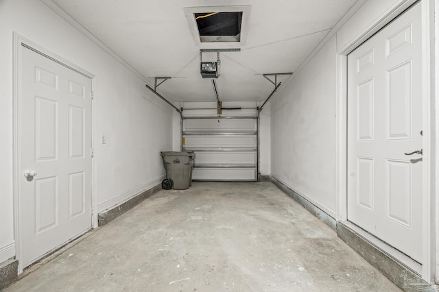 garage featuring baseboards and a garage door opener