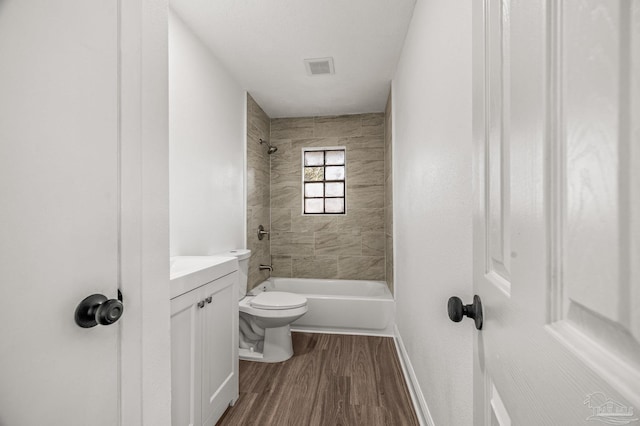 full bathroom featuring baseboards, toilet, bathtub / shower combination, wood finished floors, and vanity