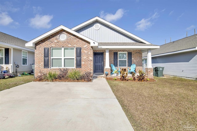 view of front of home featuring covered porch and a front yard