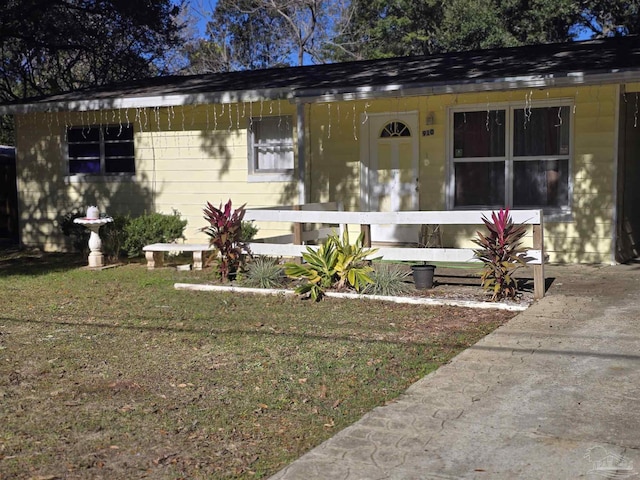 bungalow-style house with a front lawn