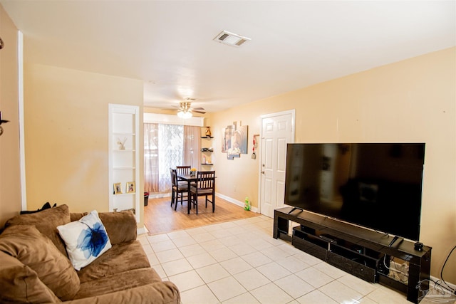 living room featuring ceiling fan and light hardwood / wood-style flooring