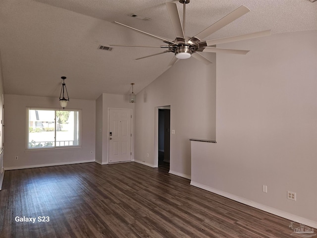 unfurnished living room featuring dark hardwood / wood-style floors, ceiling fan, a textured ceiling, and vaulted ceiling