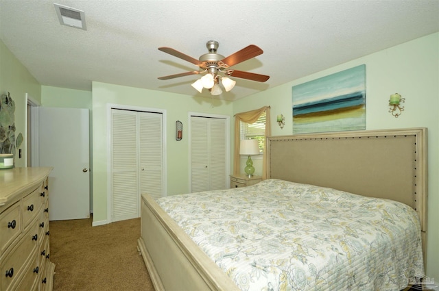 5845 Keystone Rd, Pensacola, FL 32504 - bedroom with multiple closets, carpet floors, and a ceiling fan