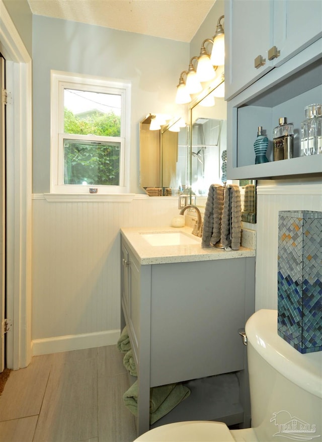 5845 Keystone Rd, Pensacola, FL 32504 - bathroom with toilet, wainscoting, vanity, and wood finished floors