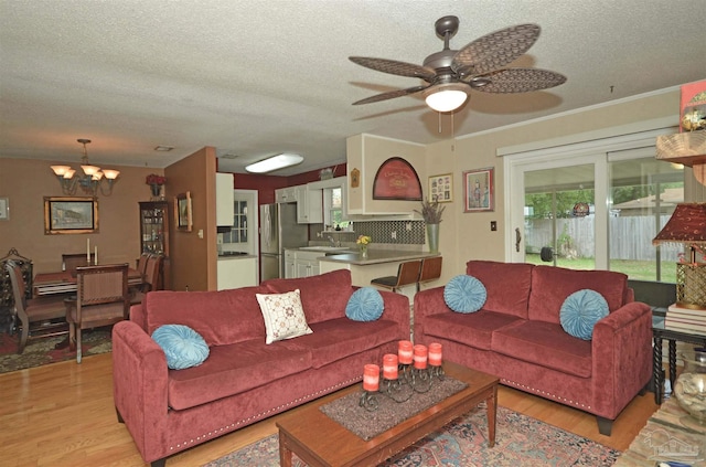 5845 Keystone Rd, Pensacola, FL 32504 - living room with light wood-style flooring, a chandelier, a textured ceiling, and ceiling fan
