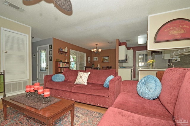 5845 Keystone Rd, Pensacola, FL 32504 - living room featuring a chandelier, a ceiling fan, and wood finished floors