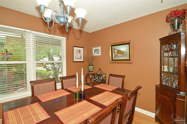 5845 Keystone Rd, Pensacola, FL 32504 - dining space with a chandelier, light wood-type flooring, and baseboards