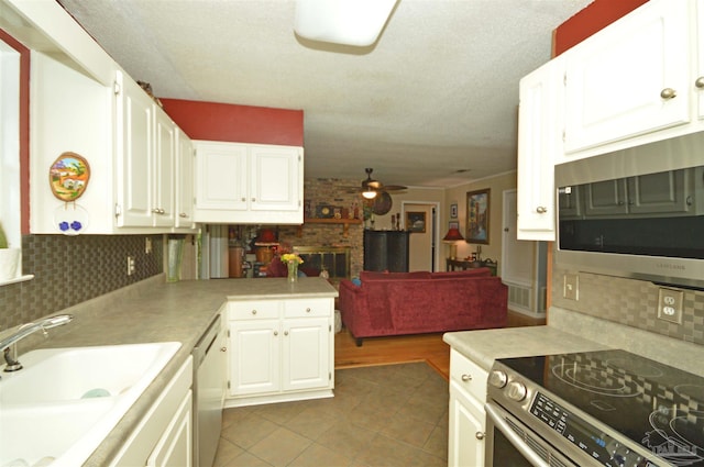 5845 Keystone Rd, Pensacola, FL 32504 - kitchen with appliances with stainless steel finishes, a sink, light tile patterned floors, ceiling fan, and light countertops