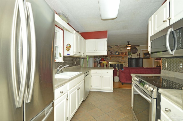 5845 Keystone Rd, Pensacola, FL 32504 - kitchen featuring stainless steel appliances, a ceiling fan, a sink, light tile patterned floors, and light countertops