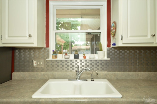 5845 Keystone Rd, Pensacola, FL 32504 - kitchen featuring a sink, decorative backsplash, and white cabinets