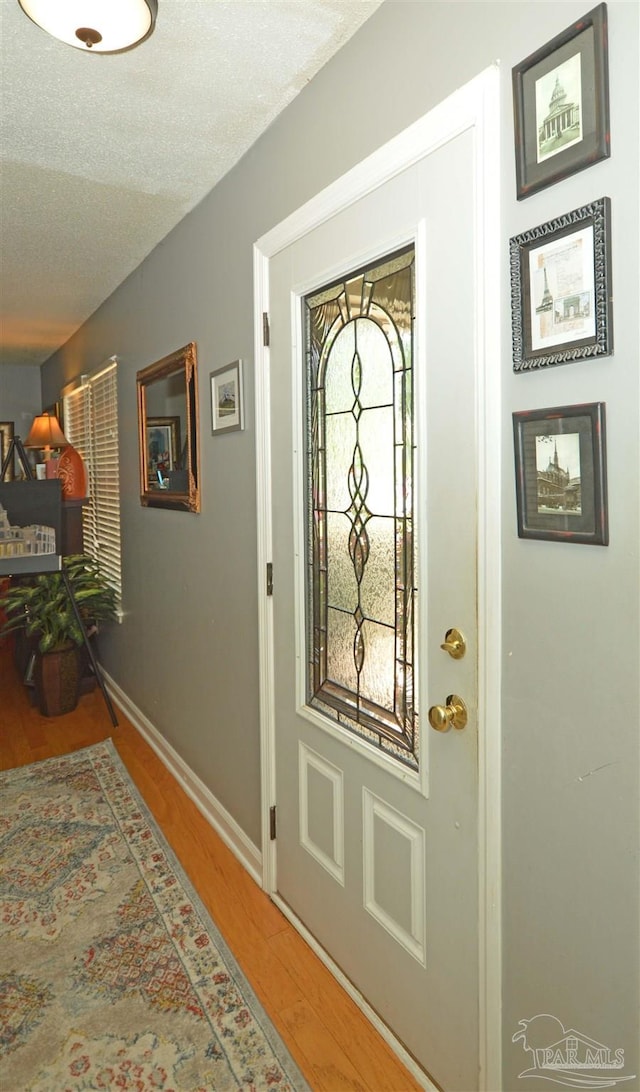 5845 Keystone Rd, Pensacola, FL 32504 - entrance foyer featuring wood finished floors, baseboards, and a textured ceiling