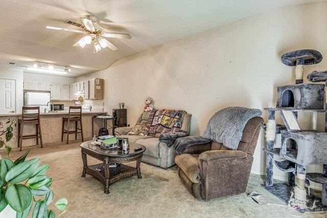 living room featuring ceiling fan and light colored carpet