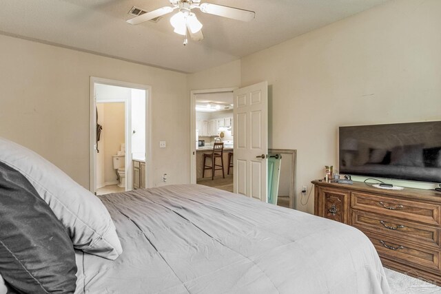 bedroom with ceiling fan and connected bathroom