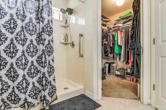 bathroom with a shower with curtain and a textured ceiling