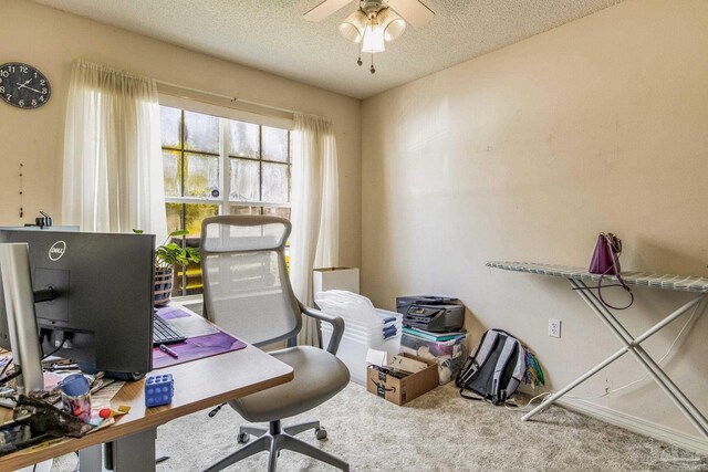 office space with carpet, a textured ceiling, and ceiling fan