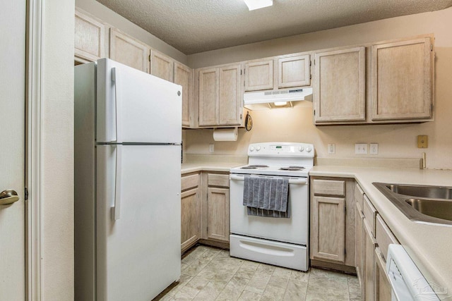 kitchen with a textured ceiling, light brown cabinets, white appliances, and sink