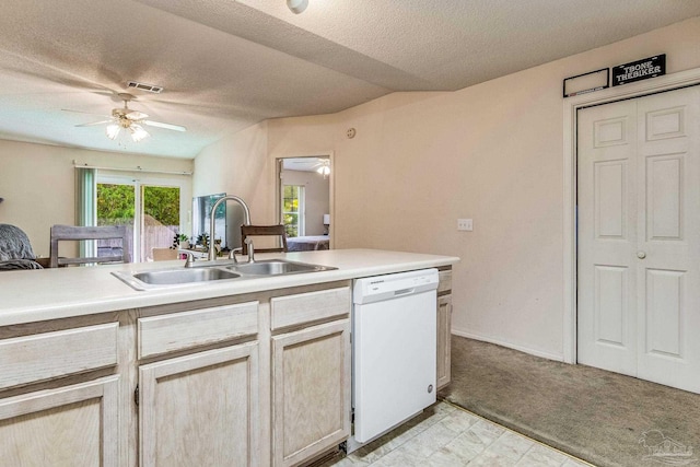 kitchen with light carpet, light brown cabinetry, a textured ceiling, white dishwasher, and sink