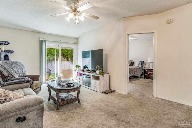 carpeted living room with ceiling fan and a textured ceiling