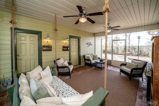 sunroom / solarium with ceiling fan and wood ceiling