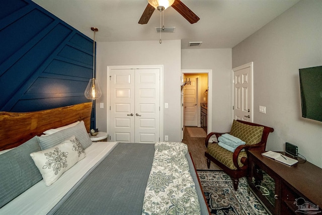 bedroom featuring hardwood / wood-style floors, a closet, and ceiling fan