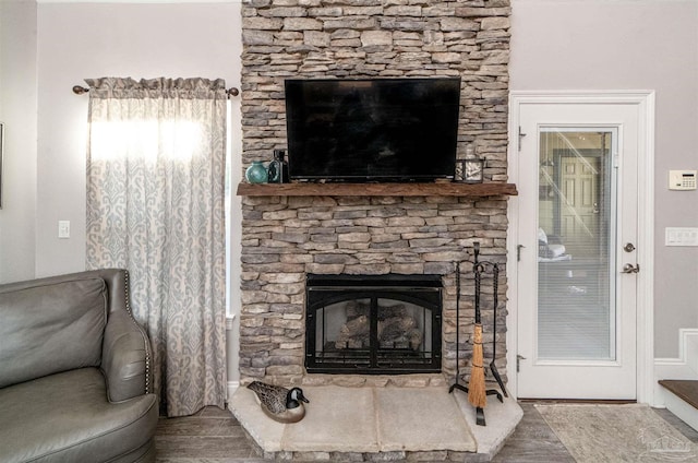 living room with a stone fireplace