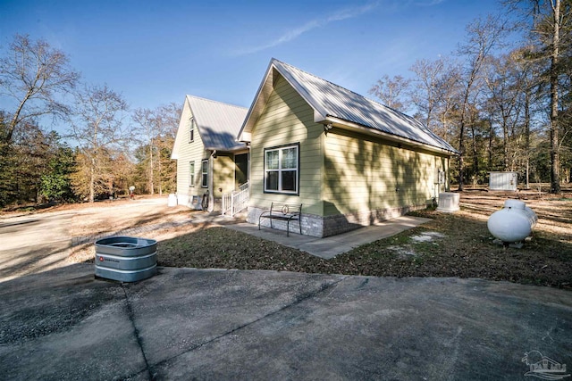 view of side of home with a patio area