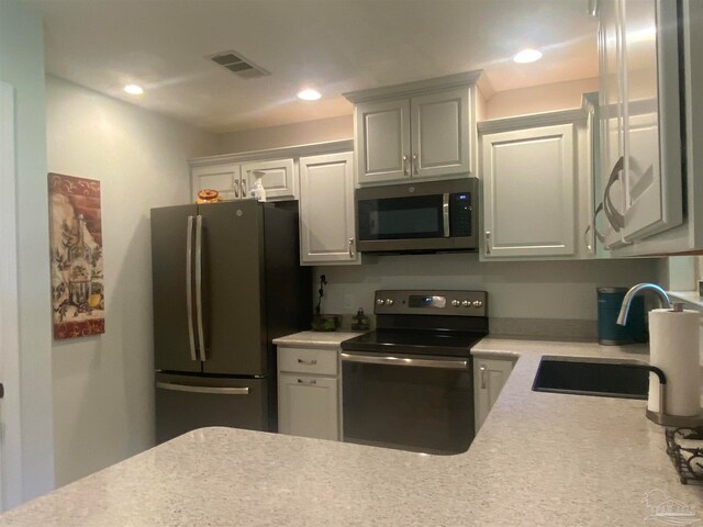 kitchen featuring white cabinetry, stainless steel appliances, and sink