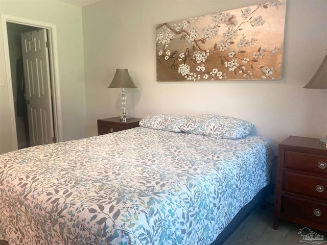 bedroom with dark hardwood / wood-style flooring