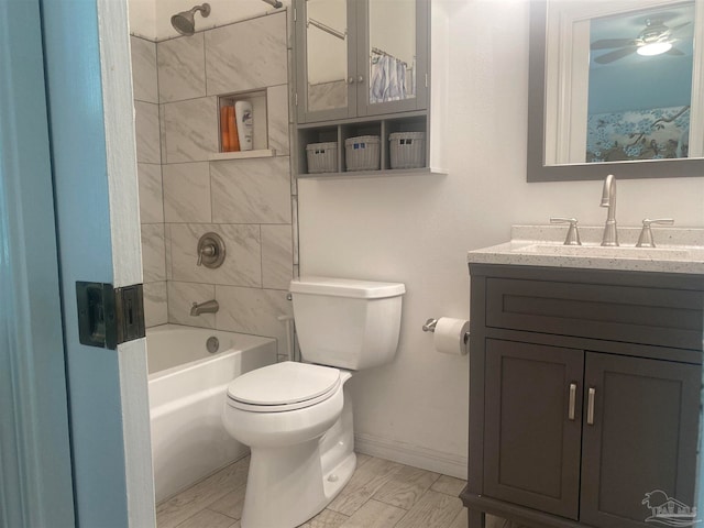 full bathroom with vanity, tiled shower / bath combo, hardwood / wood-style flooring, and toilet