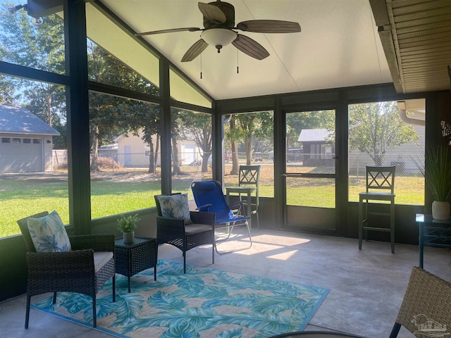 sunroom with vaulted ceiling, ceiling fan, and plenty of natural light