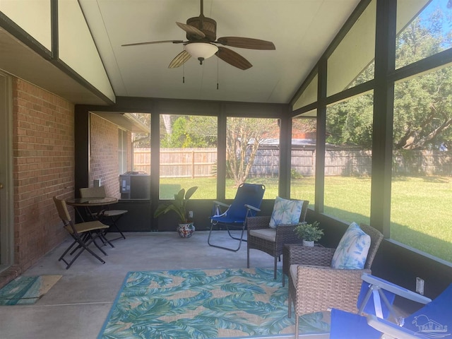 sunroom featuring ceiling fan, vaulted ceiling, and a wealth of natural light