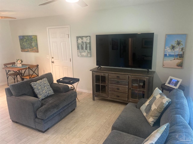 living room with ceiling fan and light hardwood / wood-style flooring