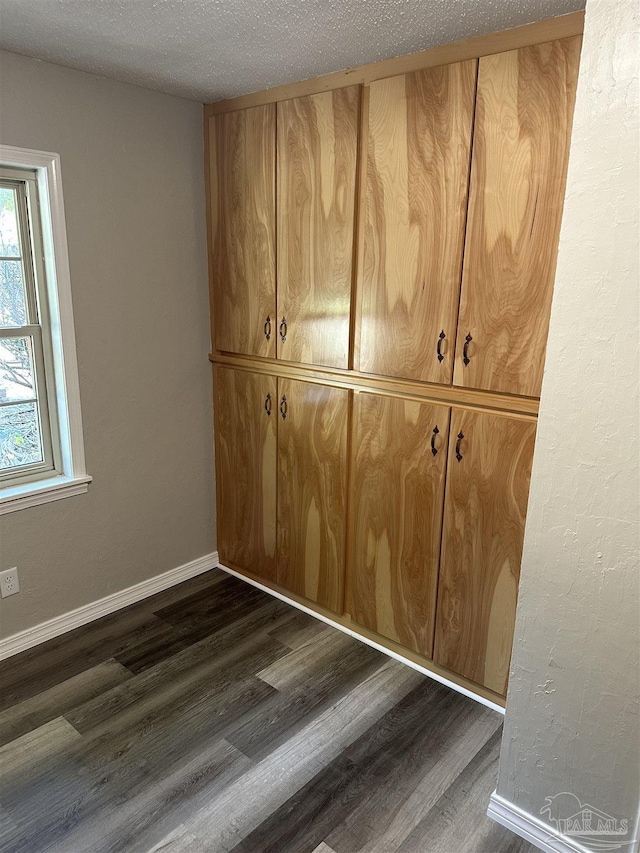 5303 Mikes Pl, Milton, FL 32570 - room details with a textured ceiling, wood finished floors, and baseboards