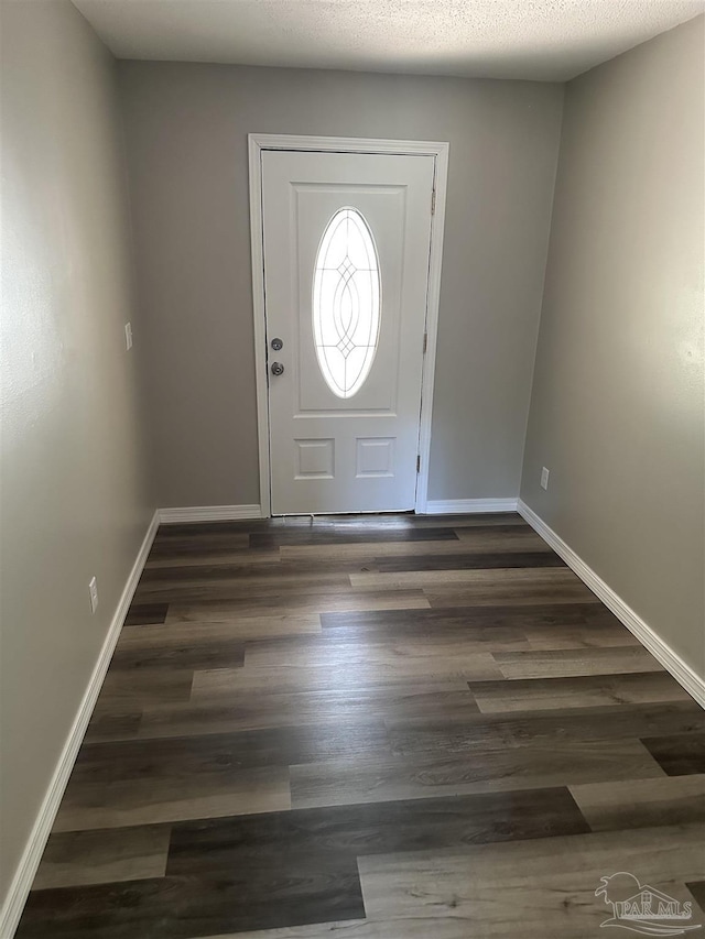 5303 Mikes Pl, Milton, FL 32570 - entrance foyer featuring a textured ceiling, dark wood-style flooring, and baseboards