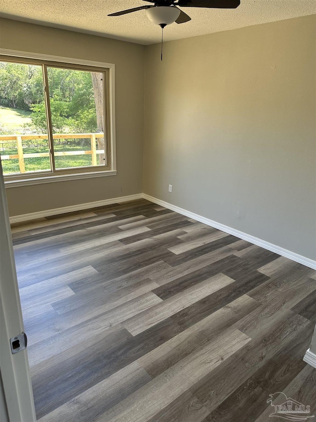 5303 Mikes Pl, Milton, FL 32570 - spare room with ceiling fan, baseboards, and dark wood-style floors